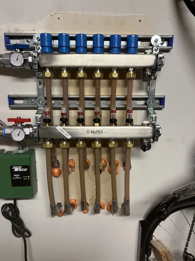 Plumber performing Water Heater Repair at a residential property in Wellsville